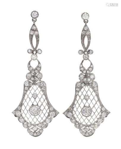 Pair of long earrings with movement, in platinum. and brilli...