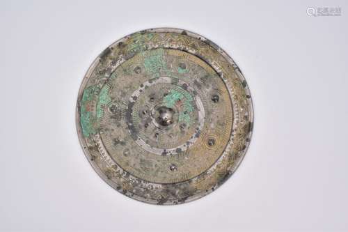 A CHINESE ARCHAIC BRONZE MIRROR, HAN DYNASTY, 206 BC – AD 22...