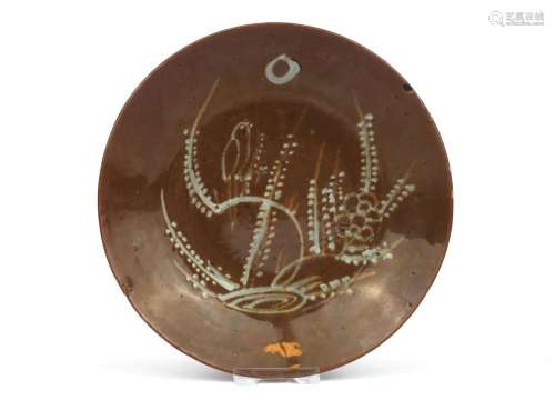 A small brown Swatow dish with slip decoration