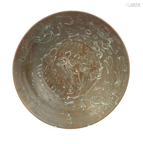 A brown Swatow dish with slip decoration