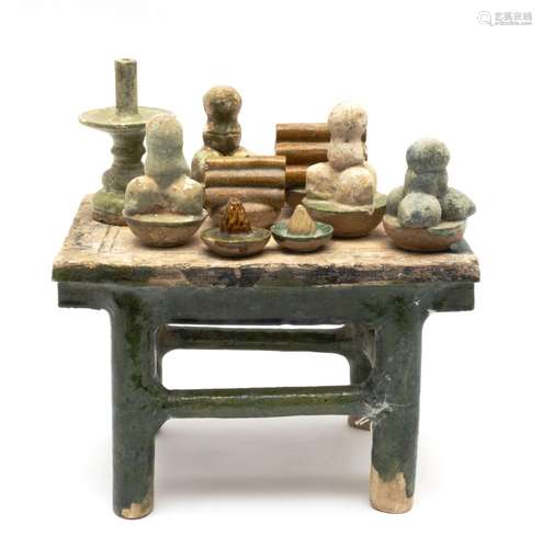 A Ming pottery table and objects