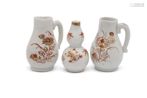 Two miniature 'milk and blood' jugs and one tiny double gour...