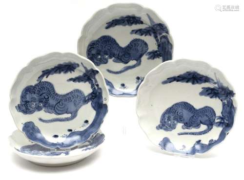 Four blue and white dishes with tigers