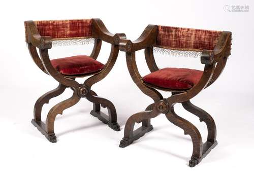 A pair of Italian walnut `Dantesca` folding armchairs