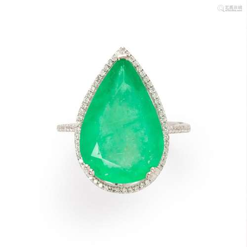 An emerald, diamond and fourteen karat white gold ring