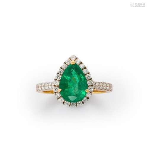 An emerald, diamond and eighteen karat gold ring