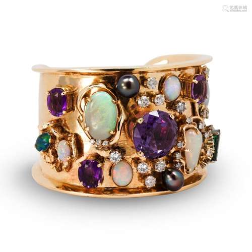 A gemstone and fourteen karat gold cuff bracelet