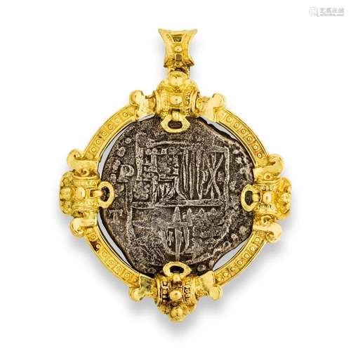 A coin and eighteen karat gold pendant