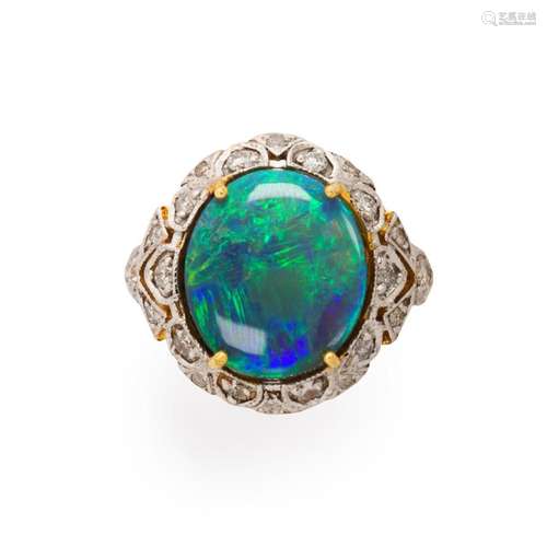 A un-treated black opal, diamond and eighteen karat bi-color...