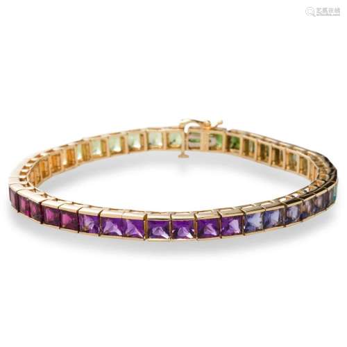 A gemstone and fourteen karat gold bracelet