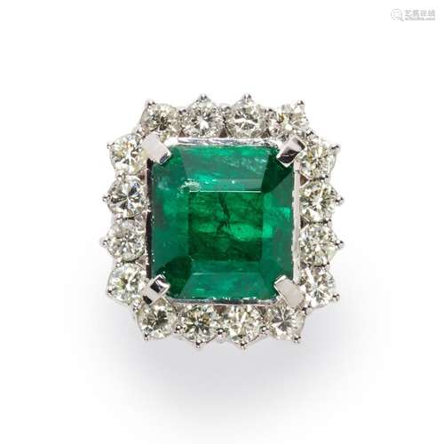 An emerald, diamond and eighteen karat white gold ring.