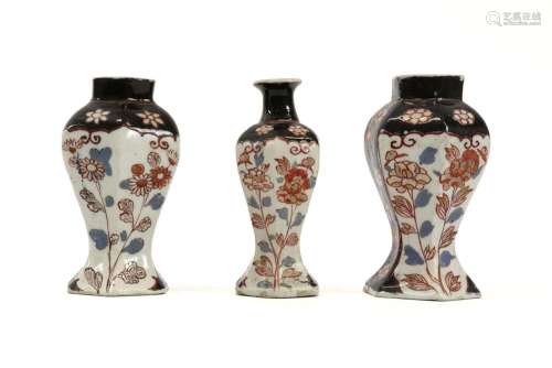 small antique garniture with three vases in porcel…