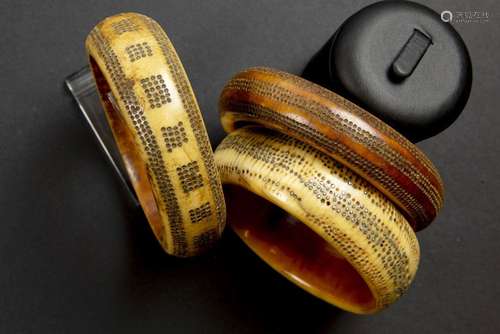 three African bone bangles with inlaid metal dots…