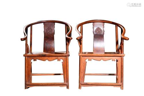 A PAIR OF CARVED HUANGHUALI HORSESHOE ARMCHAIRS.MING-QING DY...
