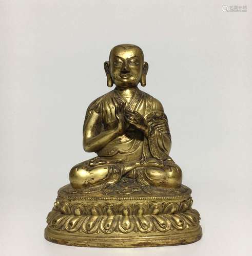 A GILT-BRONZE FIGURE OF GURU