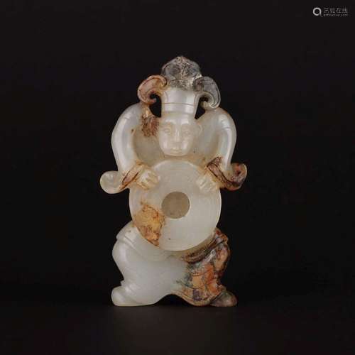 A CARVED WHITE JADE 'FIGURAL' PENDANT.WARRING STATES PERIOD