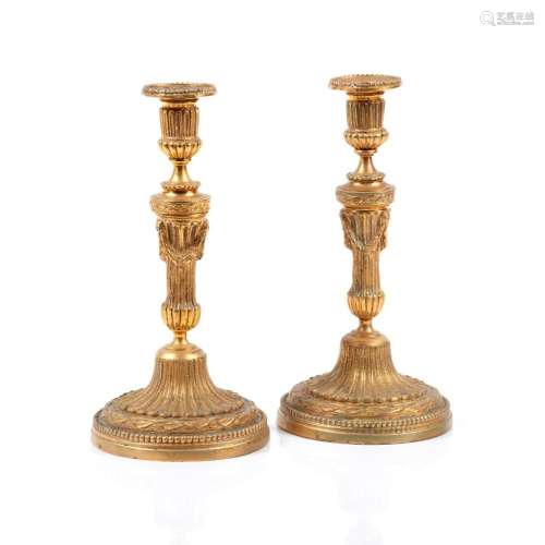 A pair of Louis XVI style candlesticks
