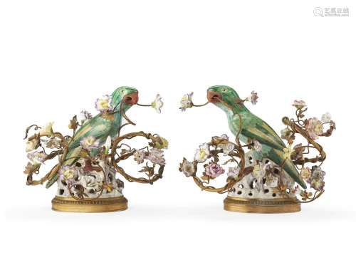 A pair of famille verte parrots mounted with gilt metal bran...