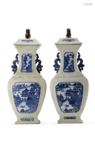 A pair of blue and white covered vases with landscape design...