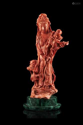 A large red coral group finely carved in the shape of a stan...