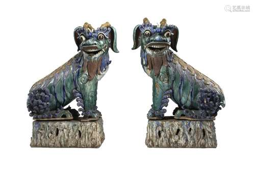 A pair of large ceramic shiwan buddhist lions (major defects...