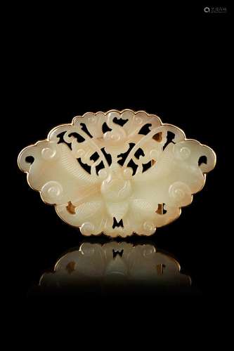 A celadon jade buckle finely carved as a butterfly with gold...