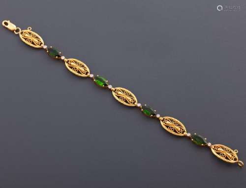 BRACELET WITH GREEN GEMS AND DIAMONDS IN 18 KT YELLOW GOLD_....