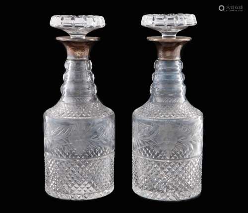 PAIR OF CARVED GLASS DECANTERS_.<br />
Glass and silver_ _Wi...