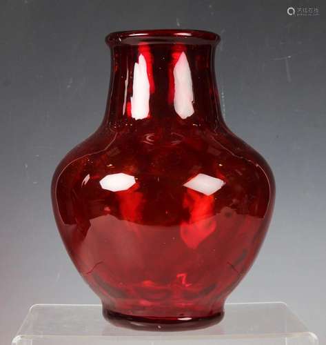 A red tinted diamond moulded glass vase