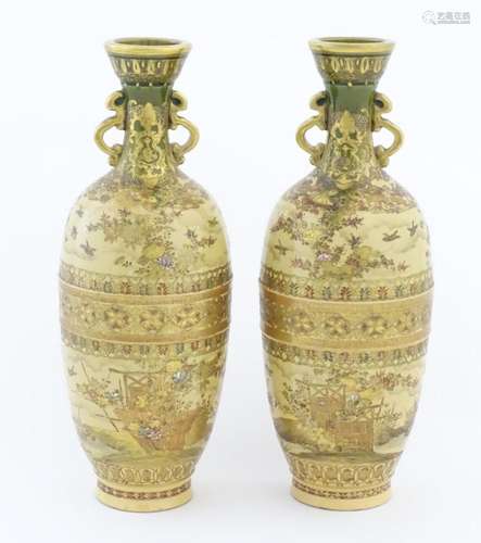 A pair of Japanese satsuma vases with twin handles decorated...