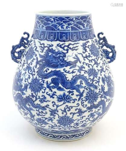 A Chinese blue and white Hu vase with scrolled twin handles,...