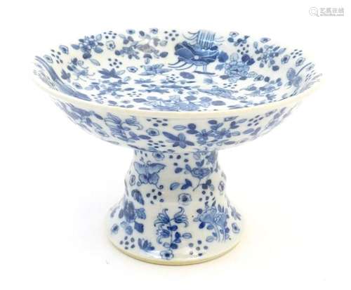 A Chinese blue and white tazza with floral, foliate, butterf...