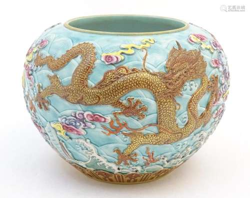 A Chinese vase / pot decorated in relief with dragons, flami...