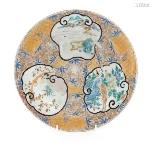 An Oriental plate with stylised panel decoration depicting l...