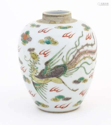 A Chinese vase decorated with phoenix and dragon amongst sty...