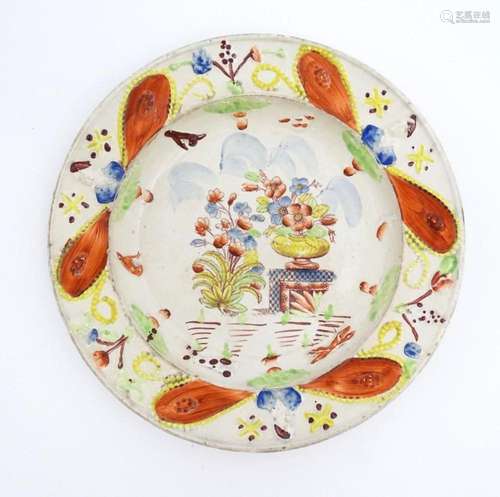 A 19thC plate decorated in Pratt colours depicting flowers a...