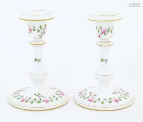 A pair of Royal Worcester candlesticks with banded rose and ...