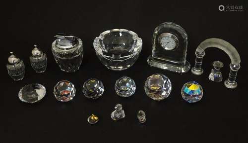 A quantity of Swarovski cut crystal comprising paperweights,...