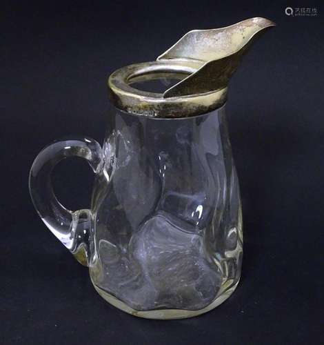 A glass jug with loop handle and silver plate mounts. Approx...