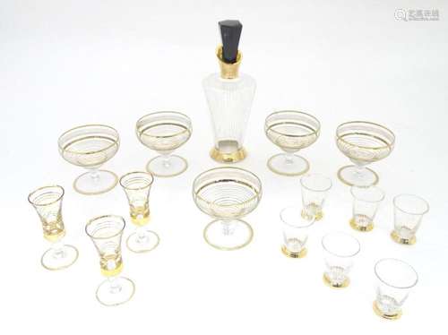 A mid 20thC liquor / schnapps decanter with various glasses ...