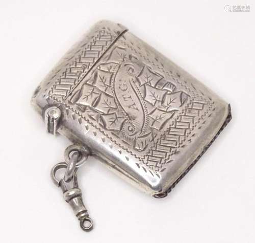 A silver vesta case with engraved foliate decoration, hallma...