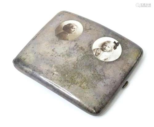 A silver cigarette case of shaped form having inset portrait...