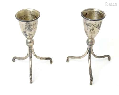 A pair of Mexican .925 silver candlesticks standing on three...