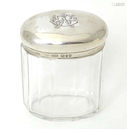 A Victorian glass dressing table jar of ovoid form with silv...