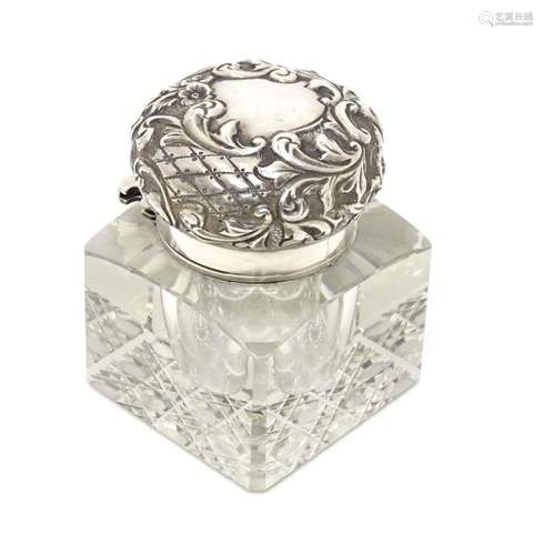 A cut glass inkwell of squared form with an embossed silver ...