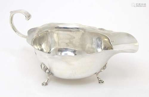 A silver sauce boat hallmarked Birmingham 1961, maker Adie B...