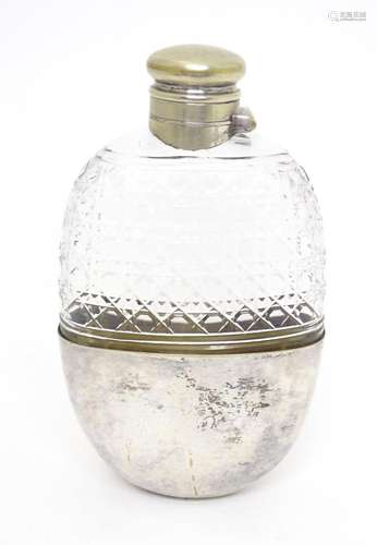 A glass hip flask of ovoid form with silver plate beaker to ...