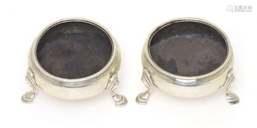 A pair of Geo III silver salts, each raised on three hoof fe...