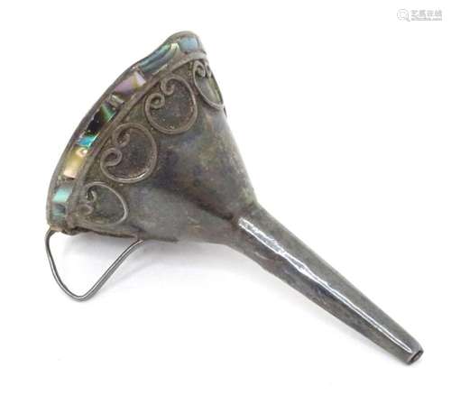 A white metal perfume funnel with abalone shell detail. Appr...