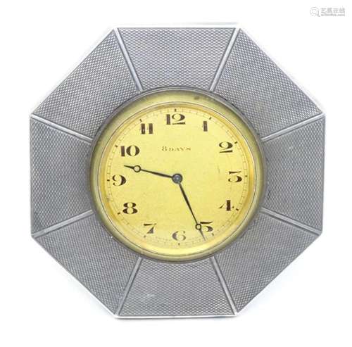 An Art Deco easel back clock with octagonal silver surround ...